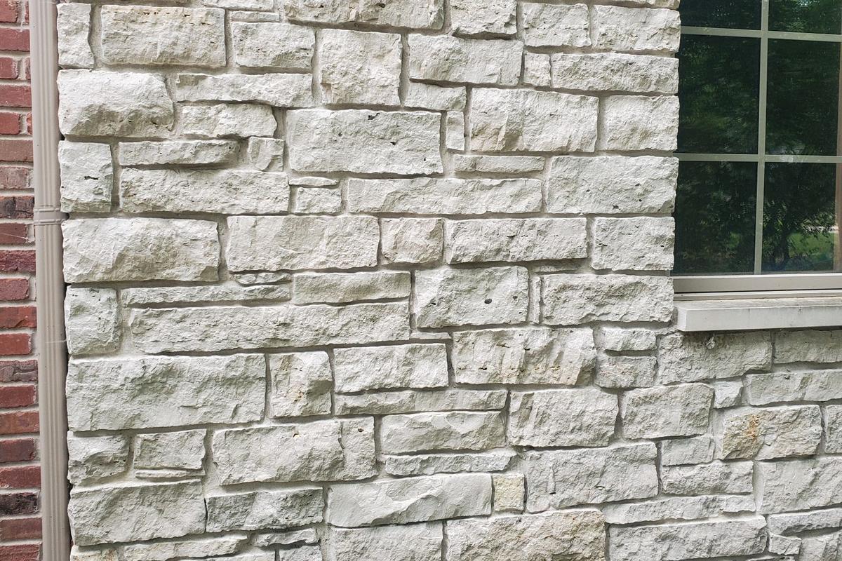 Light limestone veneer on the front of a house, installed by WJC Construction