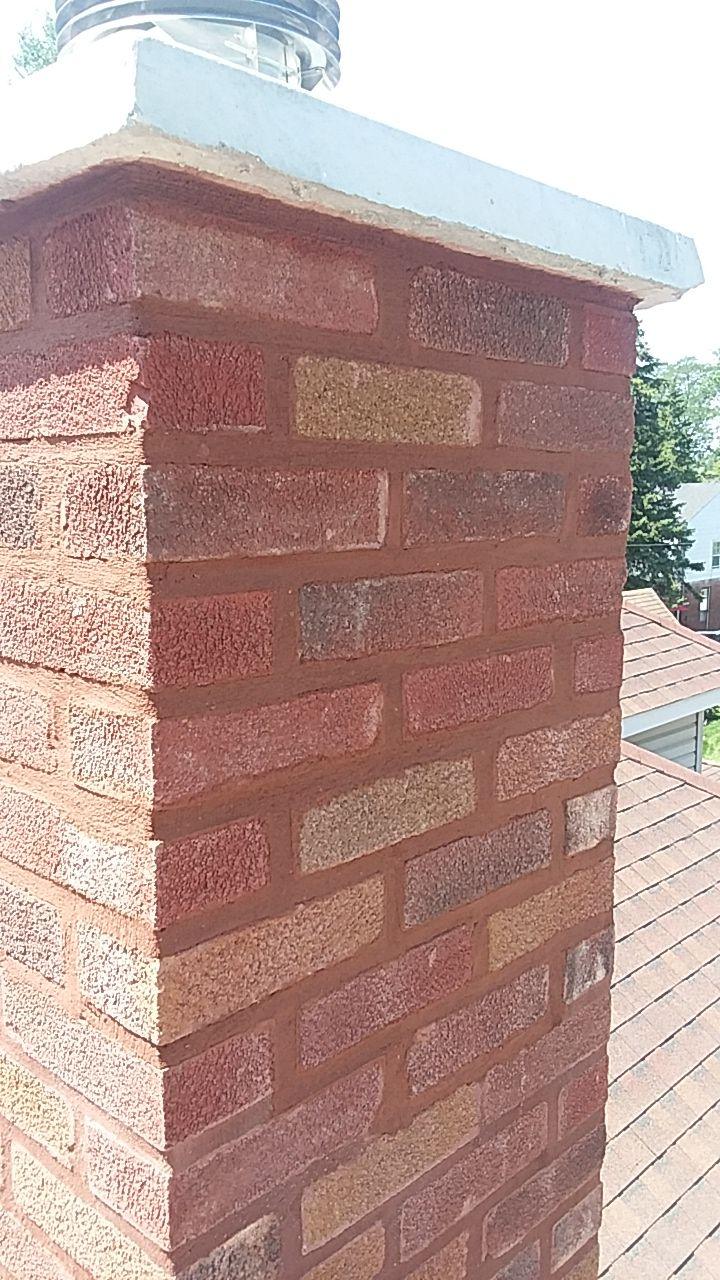 Chimney rebuild. Chimney rebuilt with matched brick and a new crown.