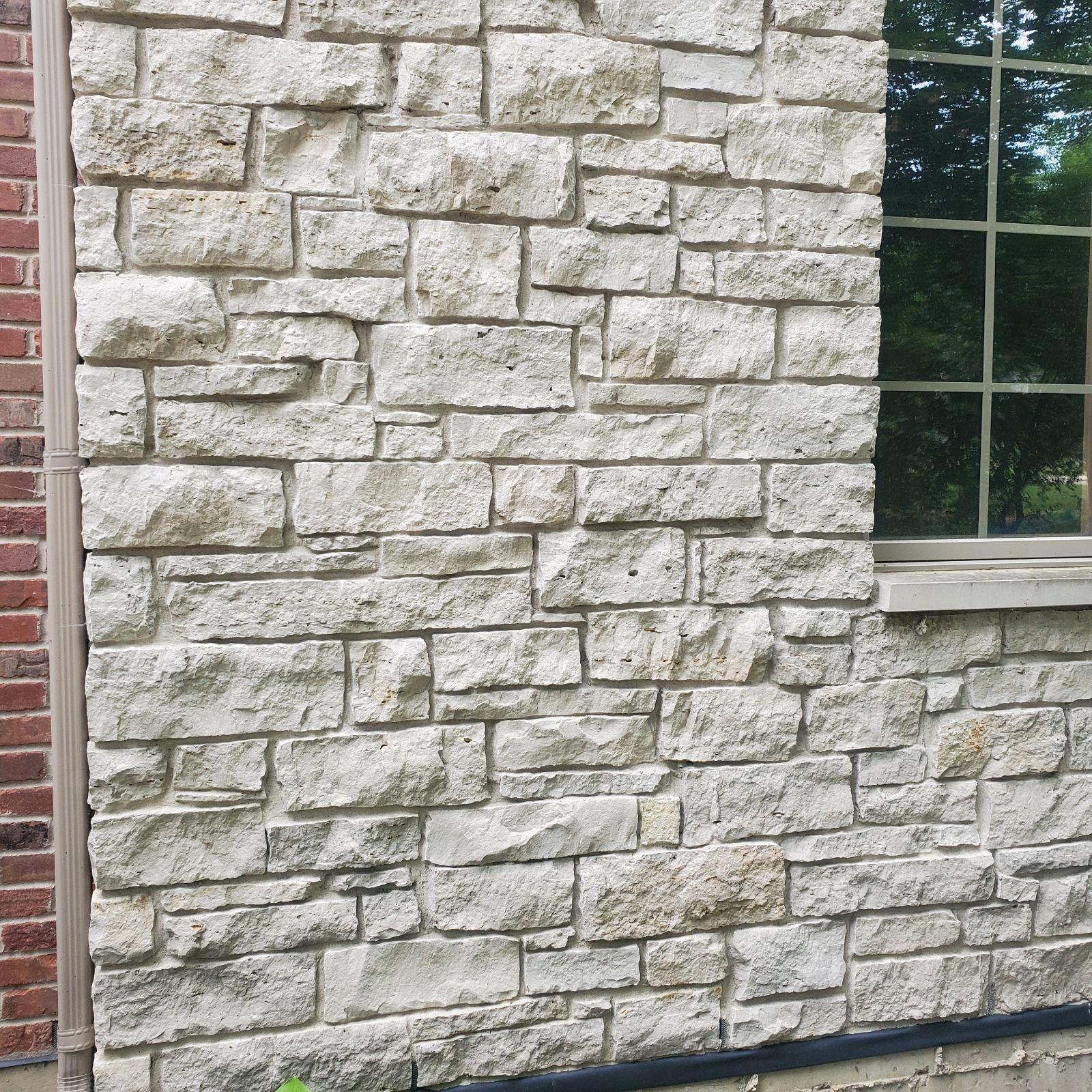 Stone veneer. Limestone veneer on the front of a house.